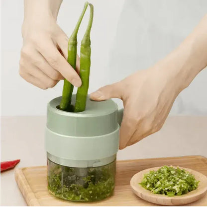Mini USB rechargeable electric food chopper for chopping garlic, onions, chilies, vegetables, herbs, and nuts with one-touch operation.
